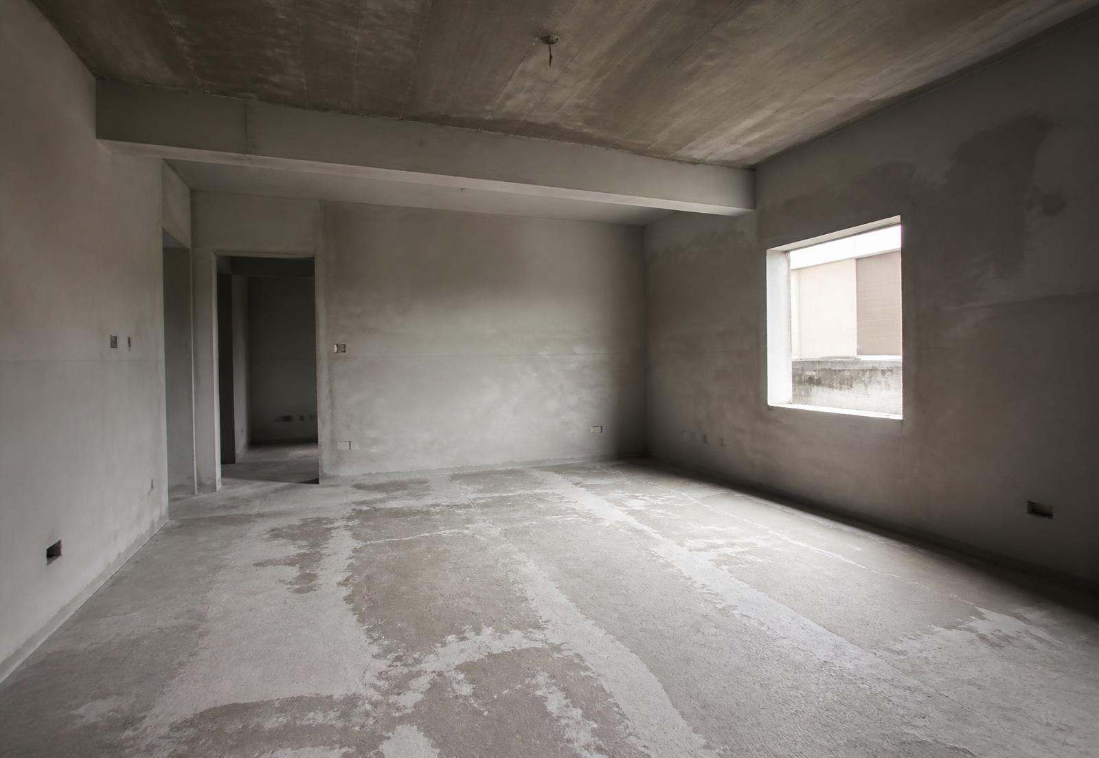 Unfinished room with bare grey plaster walls before Ben-O Homes work